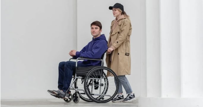Man in wheelchair with friend